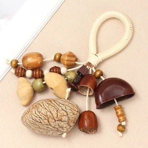 Detail of bohemian handmade pendant featuring natural seeds and wooden beads on woven cord