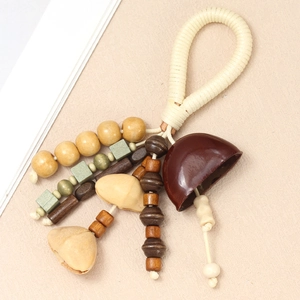 Detail of handmade ethnic tassel pendant with natural seed shells and wooden beads on cord