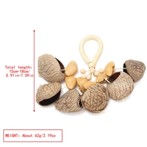 Detail view of handmade nut shell shaker with dimensions 15-18cm and 62g weight