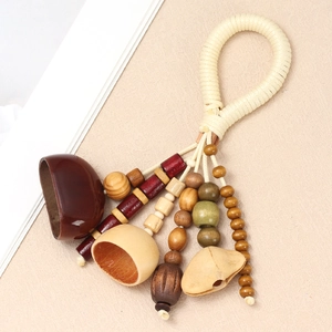 Detailed macro view of ethnic hand-woven beads and natural nut shell pendants on rope