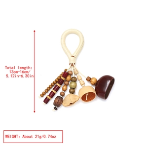 Detailed view of handmade ethnic wooden nut shell pendant with beads and braided cord