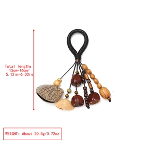 Detail showing natural seed pods and hand-woven black rope for ethnic style pendant