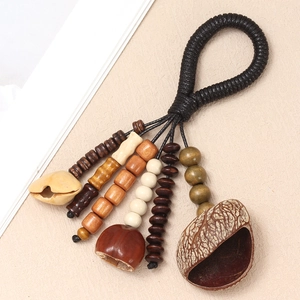 Ethnic handmade seed shell pendant with wooden beads and black woven strap keychain