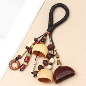 Close-up of ethnic handmade shell bell pendant with woven rope and natural wooden beads