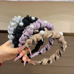 Detail of four braided headbands with pearls in silver, black, purple and champagne gold