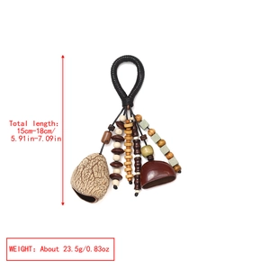 Detail view of handmade ethnic nut shell pendant with colorful beads and woven cord