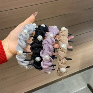 Close-up of four glitter headbands with pearl accents in grey, black, purple, and champagne