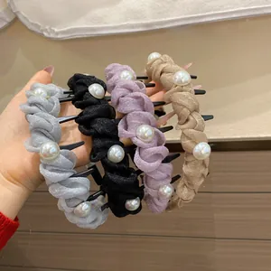 Detail of four colorful woven headbands with shimmering fabric and faux pearls