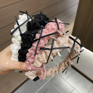 Détail de serre-têtes antidérapants en tissu plissé avec petits nœuds de ruban noir