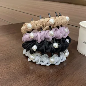 Close-up of four non-slip pearl headbands in gold, purple, black, and pearl white