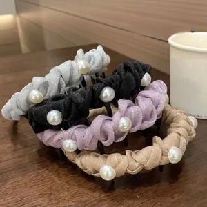 Close-up of pleated mesh headbands with pearls in silver, black, purple and gold