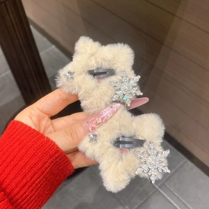 Detail shot of plush star hair clips with silver snowflake and pearl in a pair