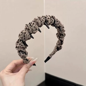 Detail of leopard print headband with non-slip teeth and pleated fabric texture
