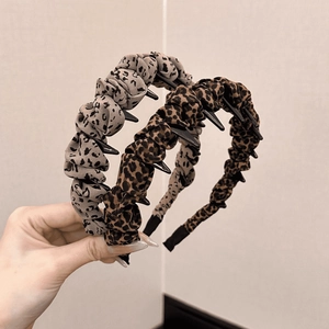 Detail of leopard print fabric headbands with non-slip inner teeth for secure grip