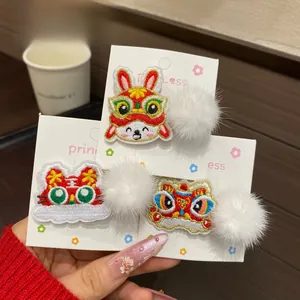 Detail of Chinese New Year embroidered hair clips with cute rabbit and lion motifs