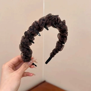 Detail shot of leopard print pleated headband with non-slip teeth for secure styling