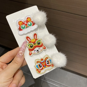 Detailed embroidery of tiger, rabbit, and lion dance patterns on festive red hair clips