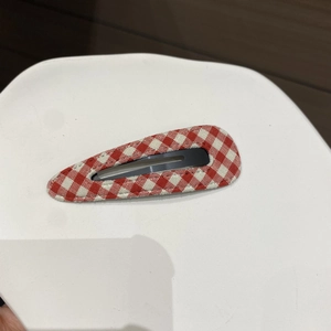 Detail of red and white plaid fabric BB hair clip with vintage cotton texture finish