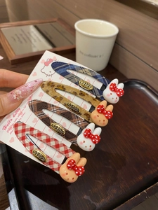 Close-up of four plaid BB hair clips featuring cute 3D bunny cartoon embellishments