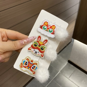 Detail of Chinese New Year hair clips with embroidered lion and rabbit patterns