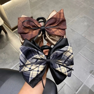 Detail of 13cm oversized checkered bow hair claw clips with multi-layer ribbon fabric