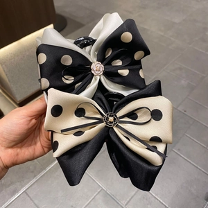 Elegant French-style polka dot bow hair clips featuring a delicate rose buckle detail