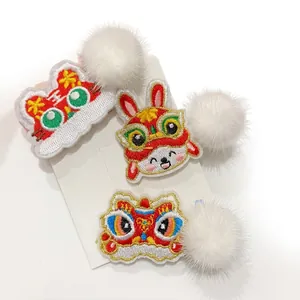 Three-piece set of red Chinese New Year embroidered hair clips with cute lion and bunny motifs