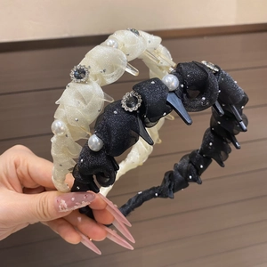 Detail of fabric wrapped headband with pearls, crystals and small braided clips