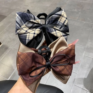 Detailed view of the layered fabric structure and texture of the 13cm ribbon bow hair claw