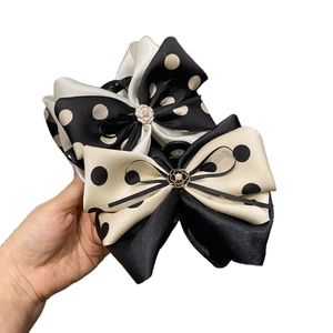 French bow hair claw clips with black and white polka dots and camellia pearl accents