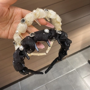 Detail of fabric-wrapped headband set with pearls, rhinestones and anti-slip comb teeth