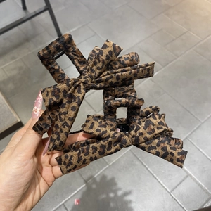 Set of two leopard print bow hair claw clips with soft velvet texture for women