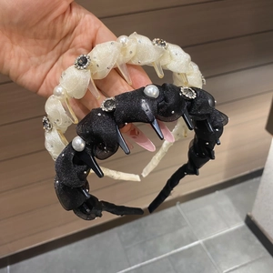 Detail of twisted fabric headband with pearls and rhinestones showing inner teeth combs