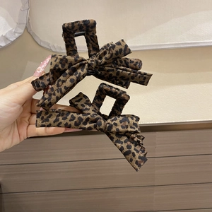 Vintage leopard print bow hair claw clip set in velvet texture for elegant hairstyling