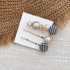 Détail d'un lot de 3 barrettes à cheveux avec perles, étoiles et tissu à motif pied-de-poule