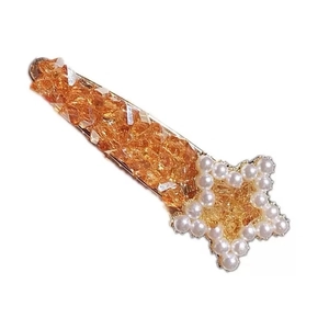Chic star hair clip with amber crystals, white pearls, and gold metal base finish