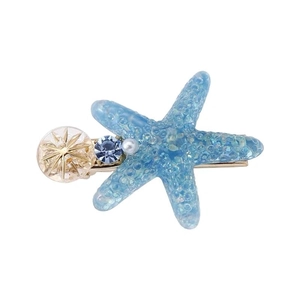 Pince à cheveux étoile de mer avec cristal bleu et perles sur une base dorée