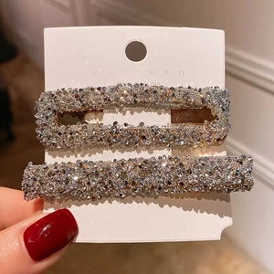 Close-up of a two-piece vintage hair clip set with sparkling rhinestone inlay details
