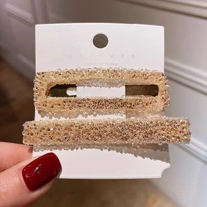 Elegant champagne gold 2-piece hair clip set with sparkling crystal inlay on white card