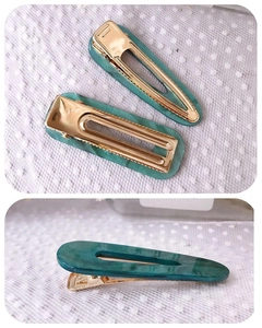 Close-up of emerald marble texture hair clips with gold metal crocodile clip base