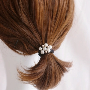 Elegant hair tie set with nine white faux pearls and golden beads on black elastic rope