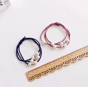 Elegant beaded hair tie set with pearls and gold metal beads on navy and pink bands