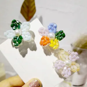Three-piece colorful crystal flower hair clips with pearls on a white display card