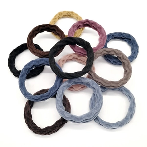 Close-up of 11 multi-colored thick seamless elastic hair ties with velvet towel texture