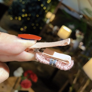 Pink handmade crochet bow hair clip for baby girls with a cute ribbon wrapped metal clip