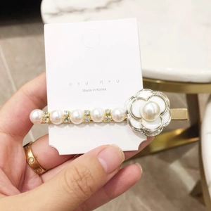 Elegant pearl and camellia hair clip with rhinestones on a gold-tone duckbill base