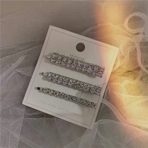 Three-piece set of elegant rhinestone hair clips with silver base on display card