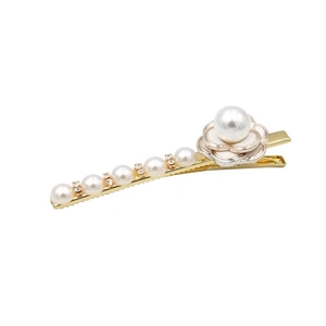 Golden camellia flower hair clip with white pearls and rhinestones in 45-degree view