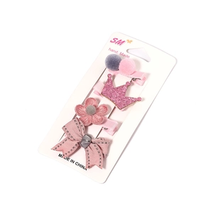 Cute 4-piece pink girls hair clip set with crown, flower, bow and pompom on display card