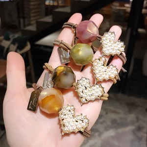 Elastic hair ties set with resin beads, pearls, and heart charms with Hand Made tags
